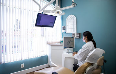 dentist at scripps west dental examining patient's data